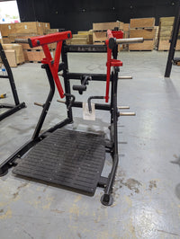 Thumbnail for Black and red independent training machine with a textured footplate and weight plate holders.