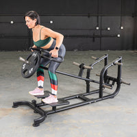 Thumbnail for Woman performing a T-bar row exercise on a black Power Leverage V2 T-Bar Row machine with a 45lb weight plate.