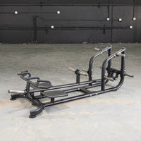 Thumbnail for Black T-bar row machine with footplate and multiple grip handles on a concrete floor.