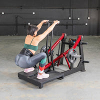 Thumbnail for Woman performing a squat on a red and black belt squat machine with weight plates.