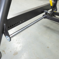 Thumbnail for Close-up of the black frame and silver bar of a fitness bench, with adjustment holes visible.