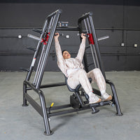Thumbnail for Woman in beige sweats using a black Power Leverage V2 Convergent Bench for an incline shoulder press.