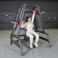 Thumbnail for Woman using a Power Leverage V2 Convergent Bench for an incline shoulder press in a gym.