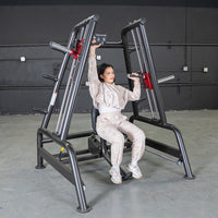 Thumbnail for Woman using a black and red shoulder press machine in a gym.