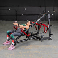 Thumbnail for Woman using a red and black decline chest fly machine in a gym.