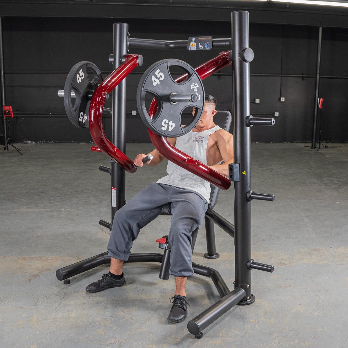 Man using a black and red decline chest press machine with 45lb weights in a gym.