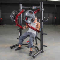 Thumbnail for Man using a black and red decline chest press machine with 45lb weights in a gym.