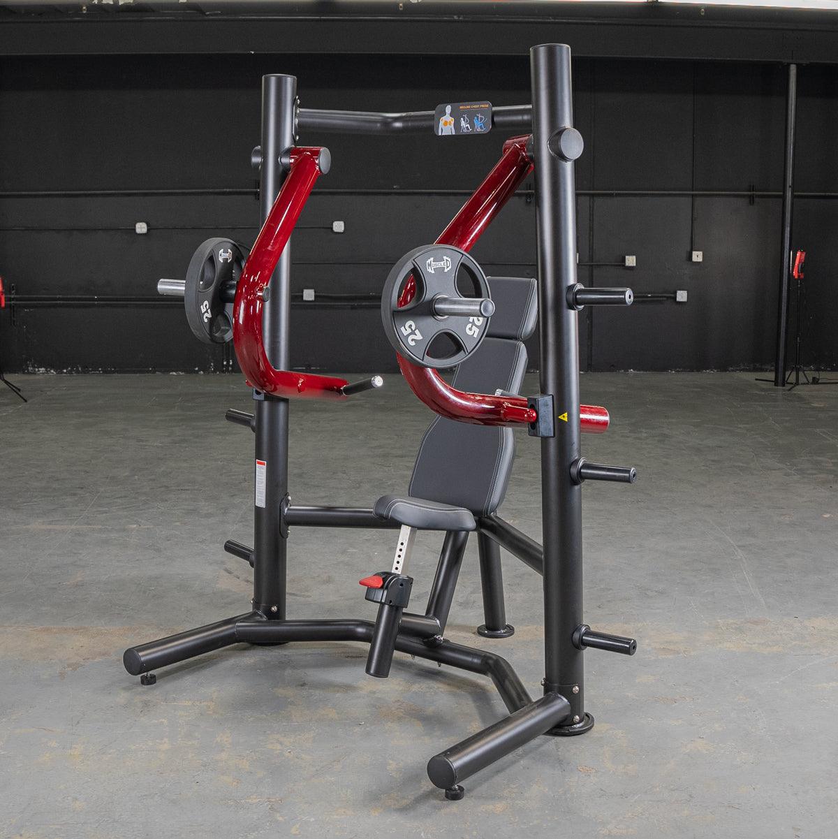 Red and black decline chest press machine with weight plates in a gym setting.