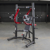 Thumbnail for Red and black decline chest press machine with weight plates in a gym setting.