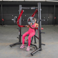 Thumbnail for Woman in pink leopard print using a red and black decline chest press machine with weight plates.