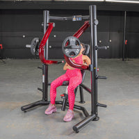 Thumbnail for Woman in pink leopard print using a red and black decline chest press machine with 25lb weights.