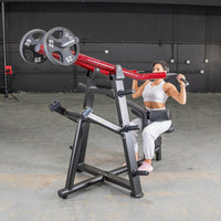 Thumbnail for Woman using a red and black iso-lateral lat pull machine with 25lb weight plates in a gym.