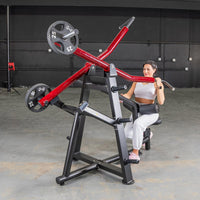 Thumbnail for Woman using a red and black iso-lateral lat pull machine with 25lb weights in a gym.