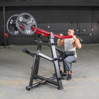 Thumbnail for Man using a red and black iso lateral lat pull machine with two 45lb plates in a gym.