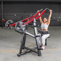 Thumbnail for Woman using a red and black lat pull machine with 25lb weights in a gym.