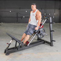 Thumbnail for Man performing hack squat on a black and red machine with a 45lb weight plate.