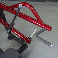 Thumbnail for Close-up of a red horizontal chest press machine with a black padded handle and weight plate holder.