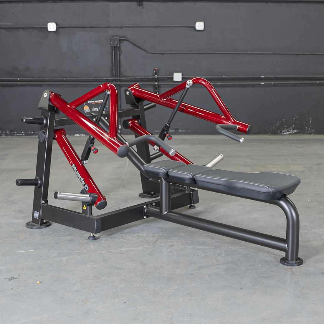 Red and black horizontal chest press machine with a black padded bench.