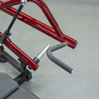 Thumbnail for Close-up of a red horizontal chest press machine with a black padded handle and silver pin.