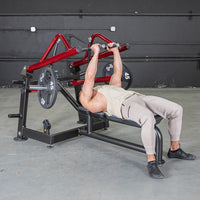Thumbnail for Man in a tank top and sweatpants using a red and black horizontal chest press machine with weights.