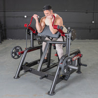 Thumbnail for Man using a black and red biceps curl machine with weight plates in a gym.