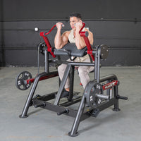 Thumbnail for Man using a black and red biceps curl machine with 25lb weight plates.