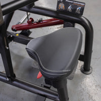 Thumbnail for Close-up of a black padded seat with white stitching on a fitness machine.