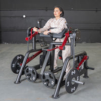 Thumbnail for Woman using a black and red biceps curl machine with weight plates in a gym.