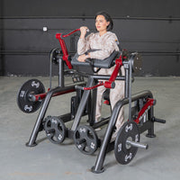 Thumbnail for Woman using a black and red biceps curl machine with weight plates in a gym.