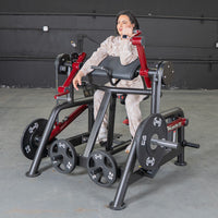 Thumbnail for Woman using a black and red biceps curl machine with weight plates in a gym.