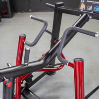 Thumbnail for Close-up of the black and red frame of a seated row machine with multiple grip handles.