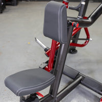 Thumbnail for Close-up of the black padded seat and backrest of a seated row machine with red accents.