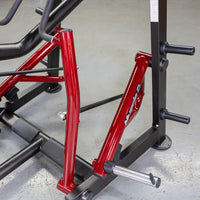 Thumbnail for Close-up of the red frame and black weight plate holders of a Muscle D Fitness Iso-Lateral Seated Row machine.