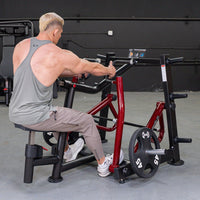 Thumbnail for Man using a red and black iso-lateral seated row machine with a 45lb weight plate.