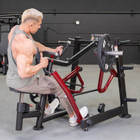 Thumbnail for Muscular man using a black and red iso-lateral seated row machine with a 45lb weight plate.