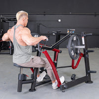 Thumbnail for Muscular man using a black and red iso-lateral seated row machine with 45lb plates in a gym.