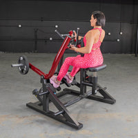 Thumbnail for Woman in pink leopard print workout gear using a red and black seated row machine with a 25lb weight.