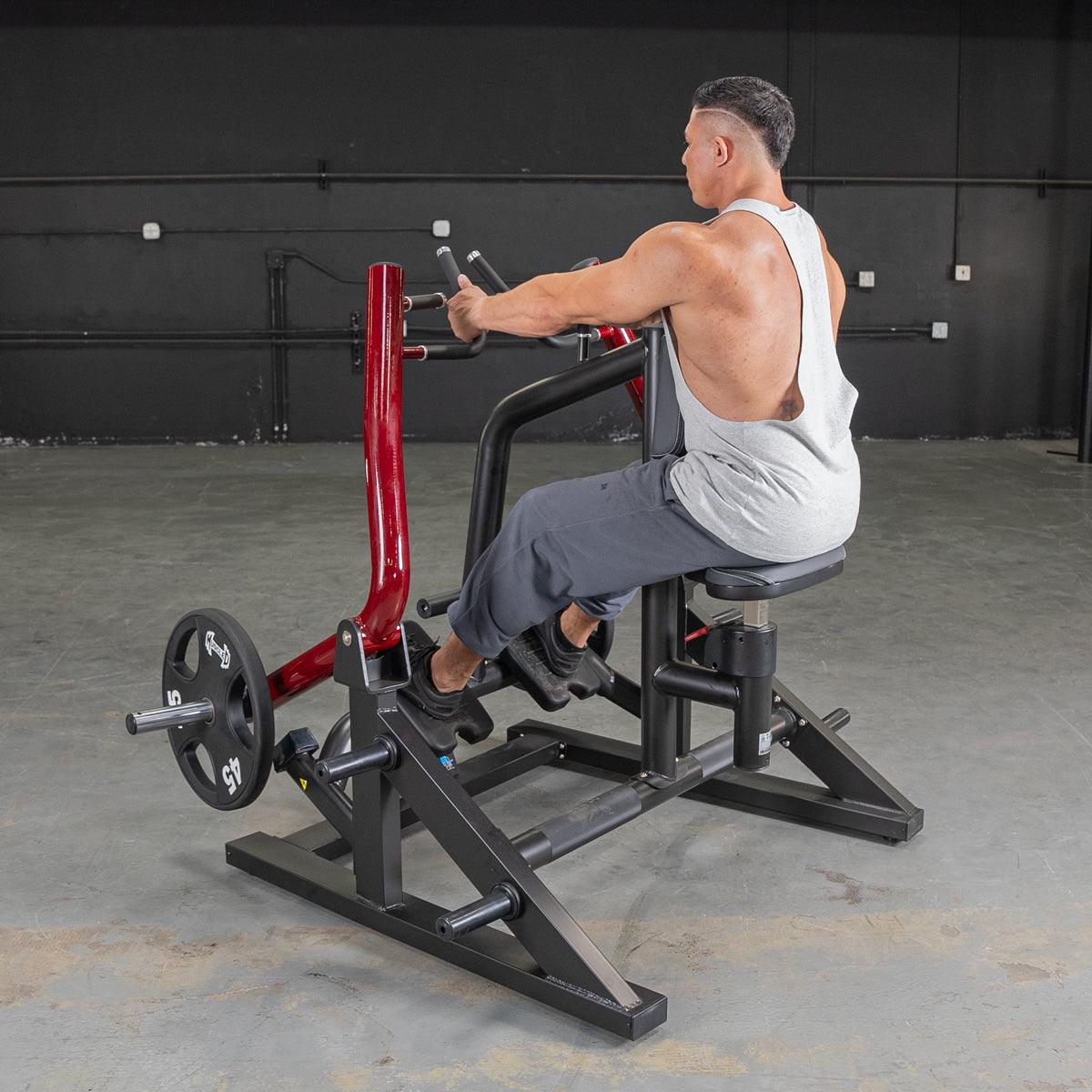 Man using a red and black seated row machine with a 45lb weight plate.