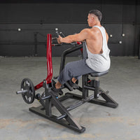 Thumbnail for Man using a red and black seated row machine with a 45lb weight plate.