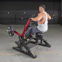 Thumbnail for Man using a red and black iso-lateral seated row machine with a 45lb weight plate.