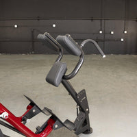 Thumbnail for Close-up of the black padded chest and arm rests, and foot plates of a red and black sprint trainer.
