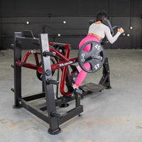 Thumbnail for Woman in pink leggings using a red and black iso lateral sprint trainer with a 45lb weight plate.