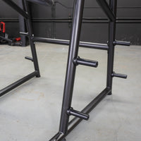 Thumbnail for Close-up of black metal frame with several horizontal pegs for weight plates.