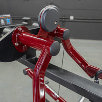 Thumbnail for Close-up of a red and black lateral raise machine with padded handles and a weight stack.