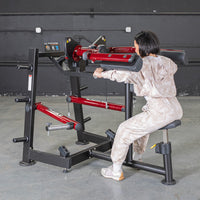 Thumbnail for Woman using a red and black lateral raise machine in a gym.