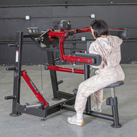Thumbnail for Woman using a red and black lateral raise machine in a gym.