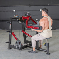 Thumbnail for Man using a red and black lateral raise machine in a gym.