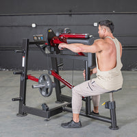 Thumbnail for Man using a red and black lateral raise machine with a 25lb weight plate.