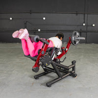 Thumbnail for Person doing a prone leg curl on a red and black combo machine with a 25lb plate.