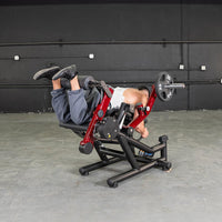 Thumbnail for Man using a red and black seated leg extension/prone leg curl machine with a 25lb weight plate.